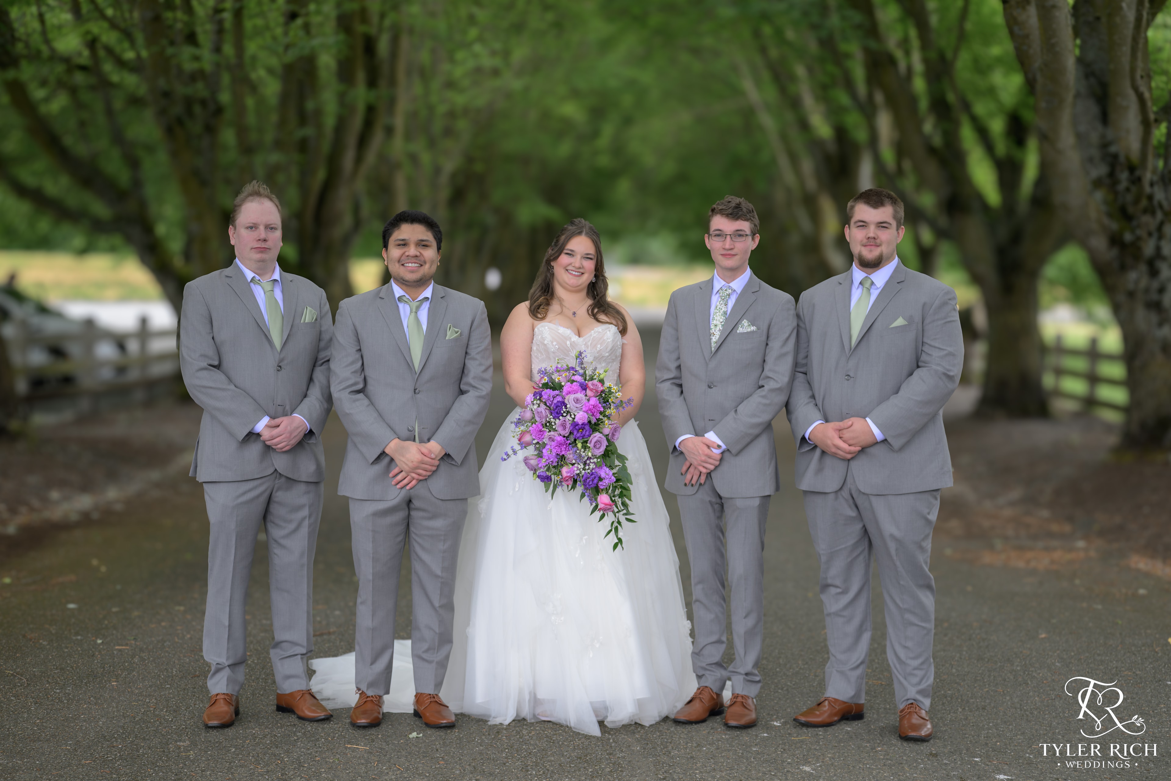 Bride and wedding party posing outdoors