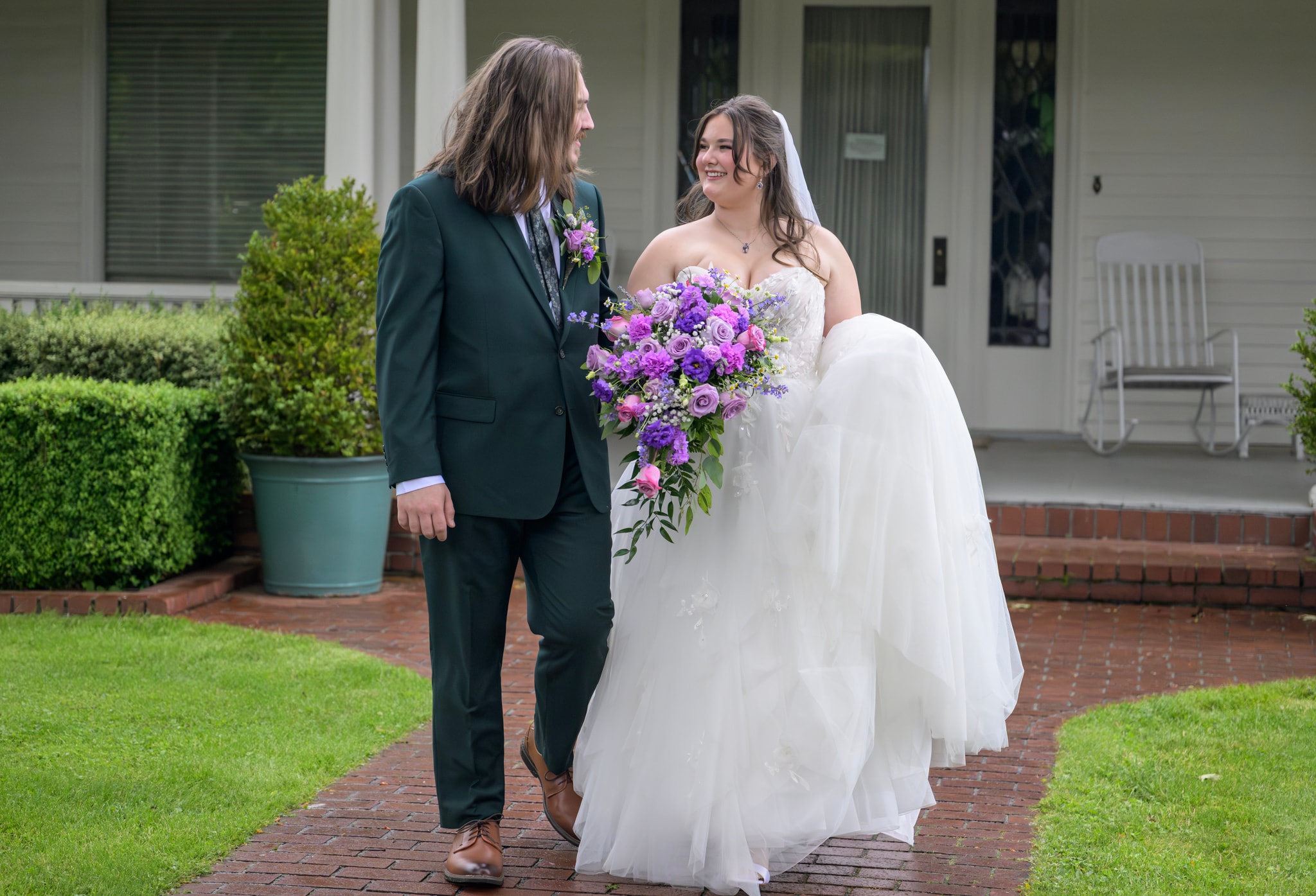 Newlywed couple walking with a bouquet
